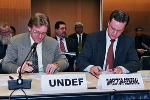 Nick Howden, UNDEF board member and Scott M. Weber, Dirctor-General of Interpeace sign partnership agreement